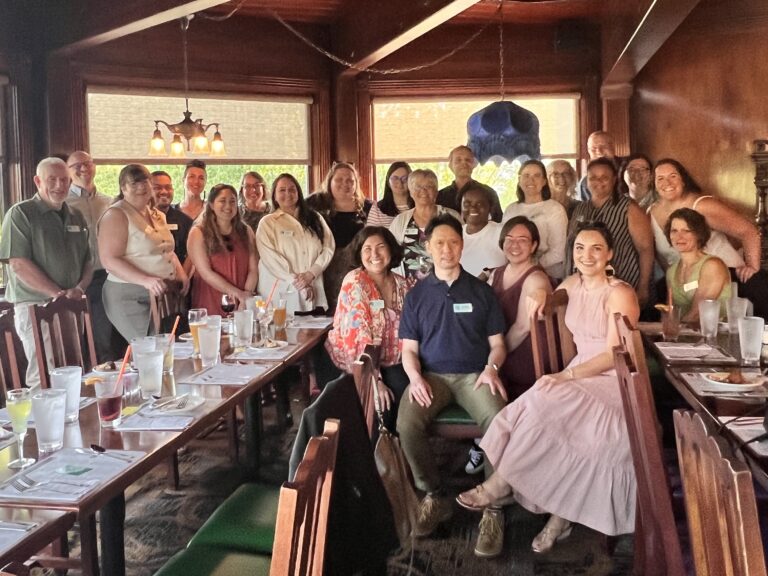 The staff and board of the Nonprofit Association of Oregon pose for a picture in a restaurant.