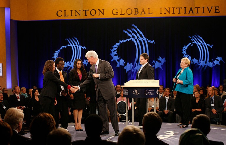 Compas-Markman receiving award from Bill Clinton